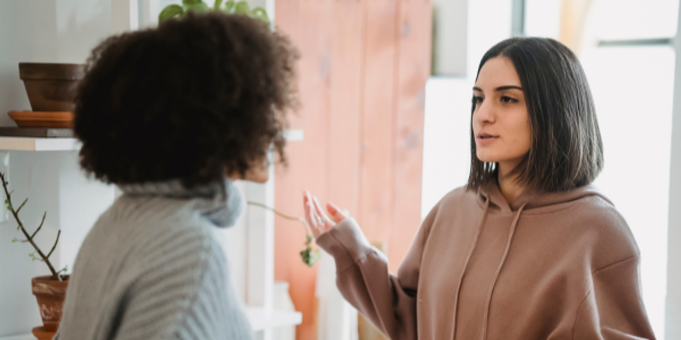A coworker addressing conflict in the workplace to another coworker